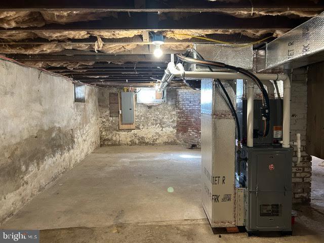 basement with electric panel and heating unit