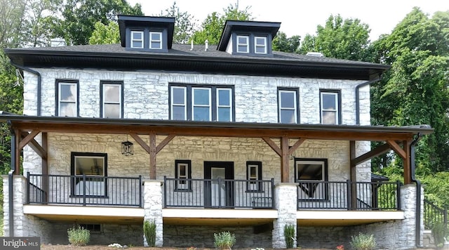 rear view of house with covered porch