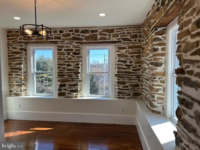 unfurnished dining area with baseboards, dark wood finished floors, a wealth of natural light, and recessed lighting