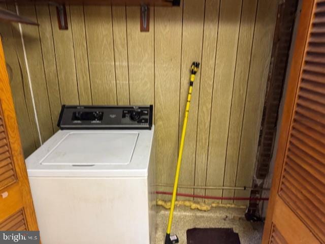 laundry room with washer / dryer and wood walls