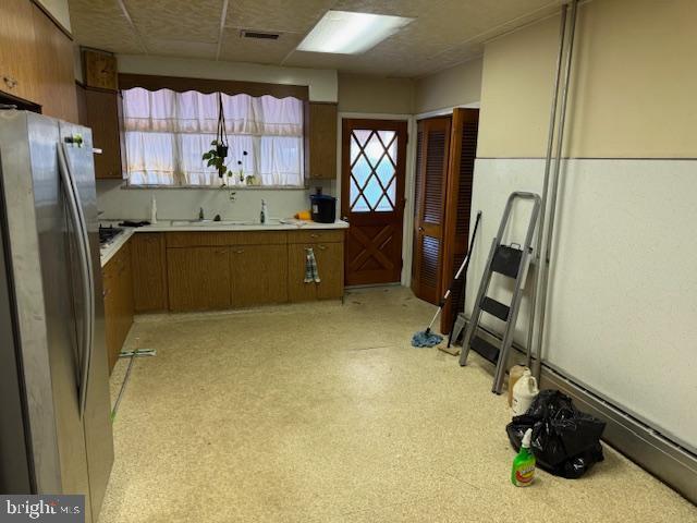 kitchen featuring sink and stainless steel fridge