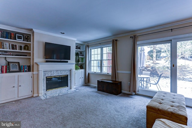 living room featuring a fireplace, ornamental molding, and light carpet