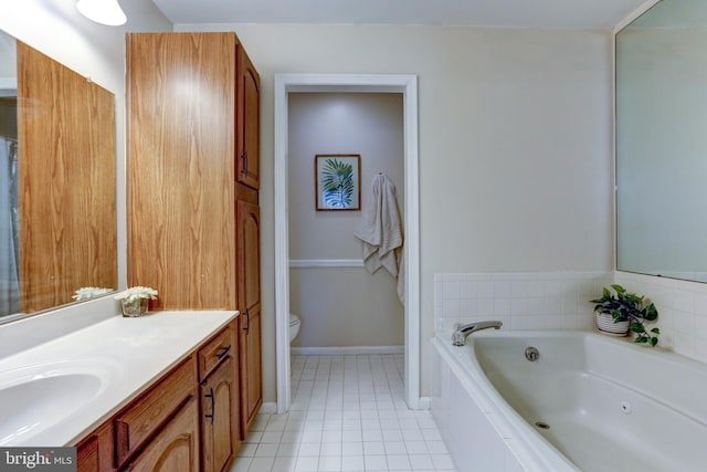 bathroom featuring toilet, tiled tub, tile patterned flooring, and vanity