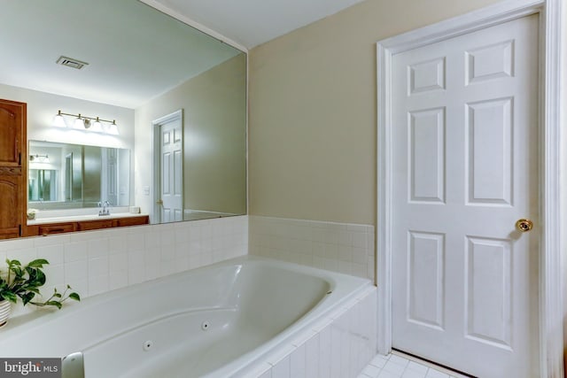 bathroom with tiled bath and tile patterned floors