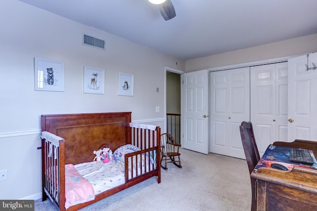 carpeted bedroom featuring ceiling fan and a closet