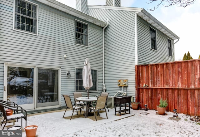 view of snow covered rear of property