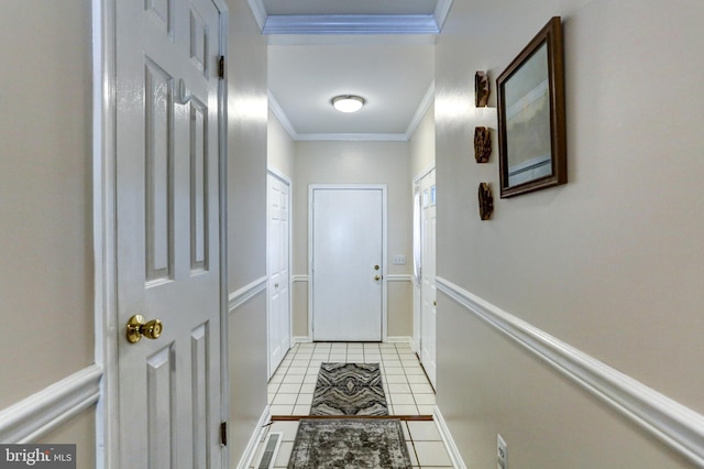 doorway to outside featuring crown molding and light tile patterned floors