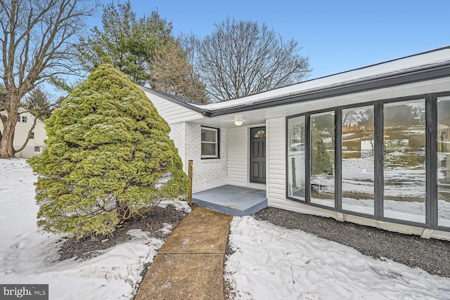 view of snow covered property entrance