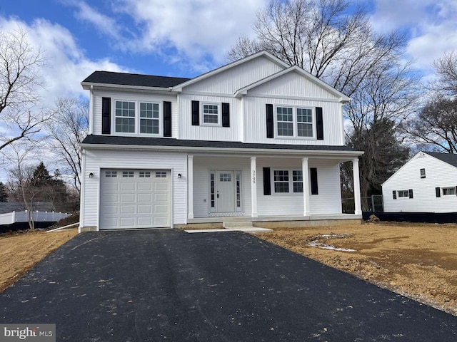 view of front of house featuring a porch and a garage