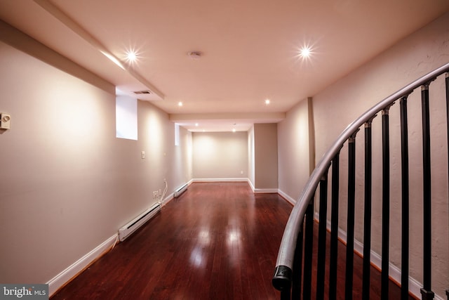 hall with dark hardwood / wood-style floors and a baseboard heating unit