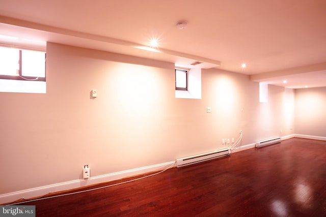 basement with hardwood / wood-style floors and a baseboard radiator