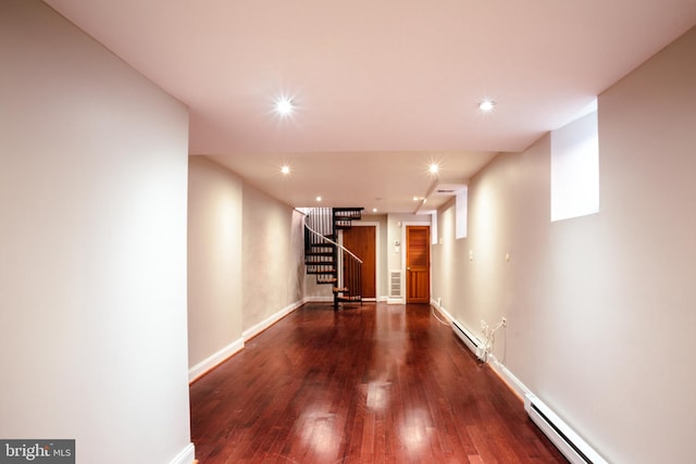 hall with dark hardwood / wood-style flooring and a baseboard heating unit