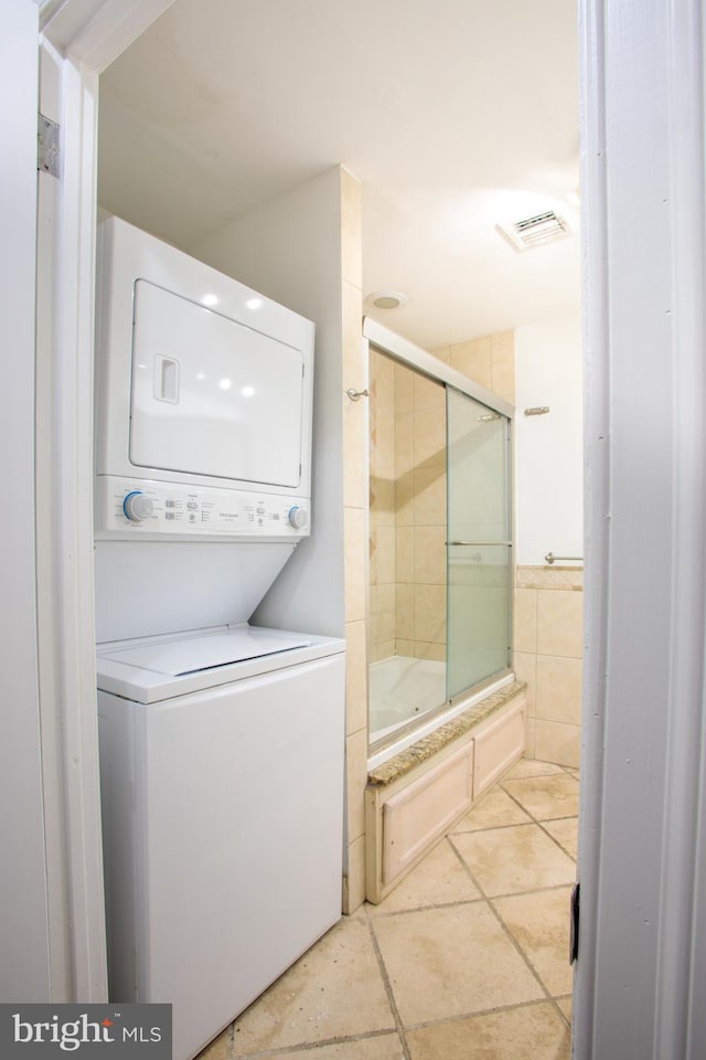 laundry room featuring stacked washing maching and dryer