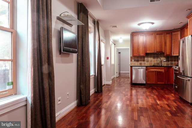 kitchen featuring decorative backsplash, sink, dark wood-type flooring, and appliances with stainless steel finishes