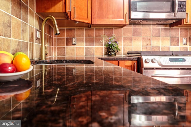 kitchen with backsplash, sink, and range