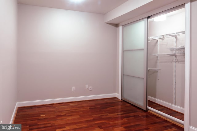 unfurnished bedroom with dark wood-type flooring