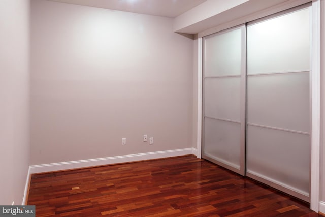 unfurnished bedroom with dark hardwood / wood-style floors