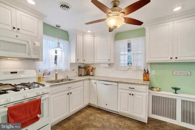 kitchen featuring white appliances, ceiling fan, sink, white cabinetry, and hanging light fixtures