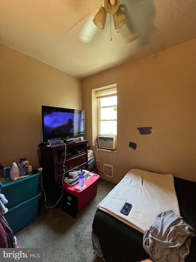 bedroom featuring cooling unit, carpet floors, and ceiling fan