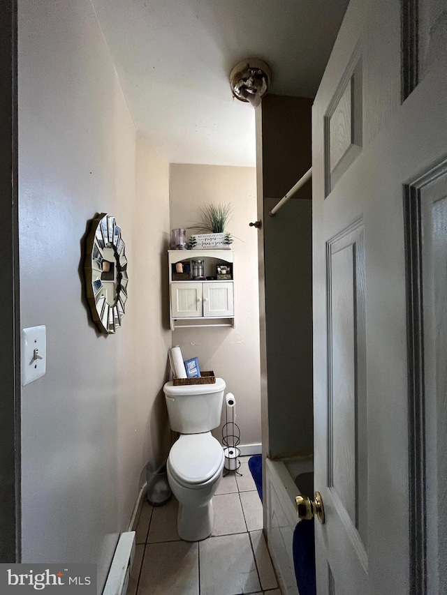 bathroom featuring toilet, a baseboard heating unit, and tile patterned flooring