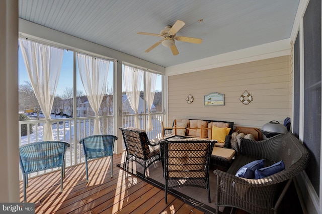 sunroom / solarium featuring ceiling fan