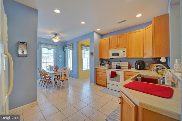 kitchen with ceiling fan, white appliances, sink, and light tile patterned floors