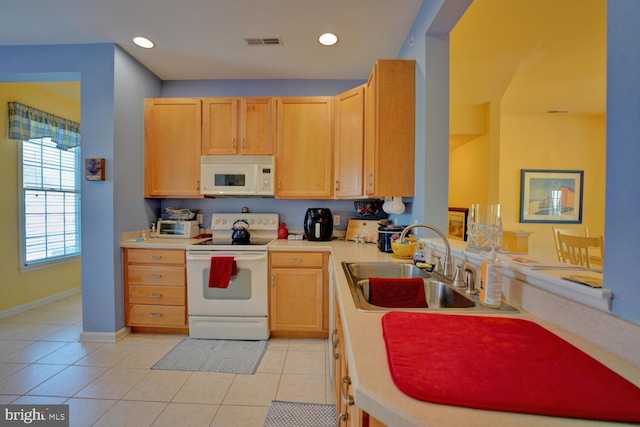 kitchen featuring light brown cabinets, white appliances, light tile patterned floors, and sink