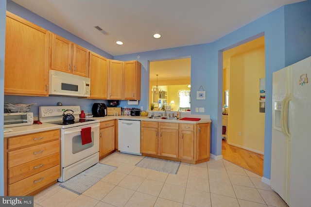 kitchen featuring sink, white appliances, a notable chandelier, and light tile patterned flooring