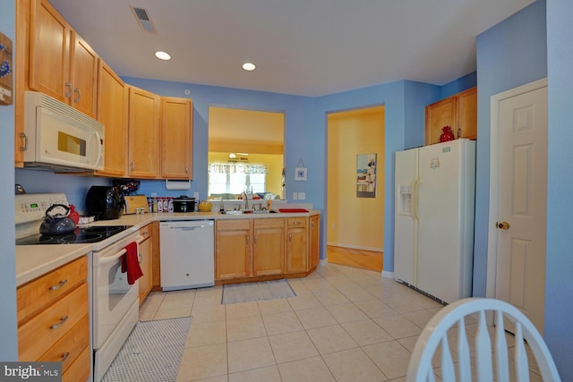 kitchen with light tile patterned flooring, white appliances, and sink