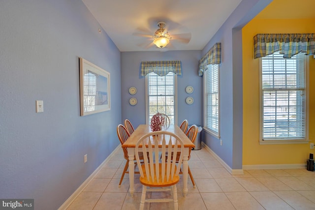 tiled dining room featuring ceiling fan