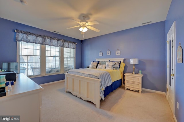 bedroom with ceiling fan and light carpet