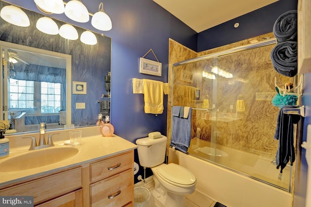 full bathroom featuring shower / bath combination with glass door, ceiling fan, vanity, and toilet