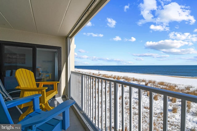 balcony with a beach view and a water view