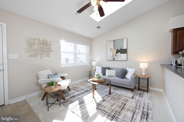 tiled living room featuring ceiling fan and lofted ceiling