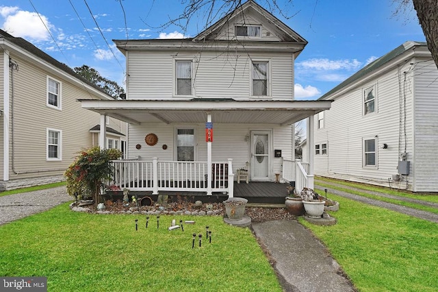 front of property with a front yard and covered porch