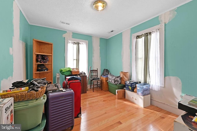 home office featuring a textured ceiling, hardwood / wood-style floors, and plenty of natural light