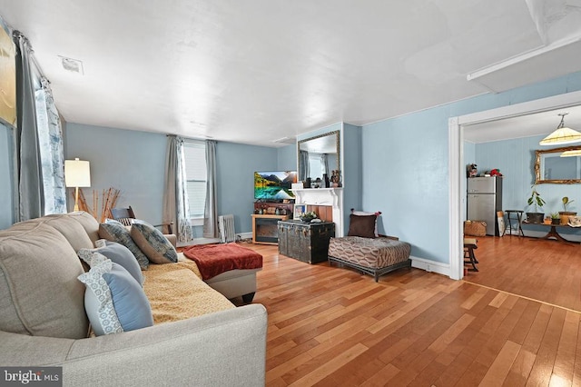 living room with wood-type flooring and radiator