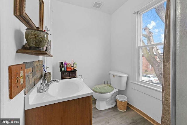 bathroom with toilet, wood-type flooring, and vanity