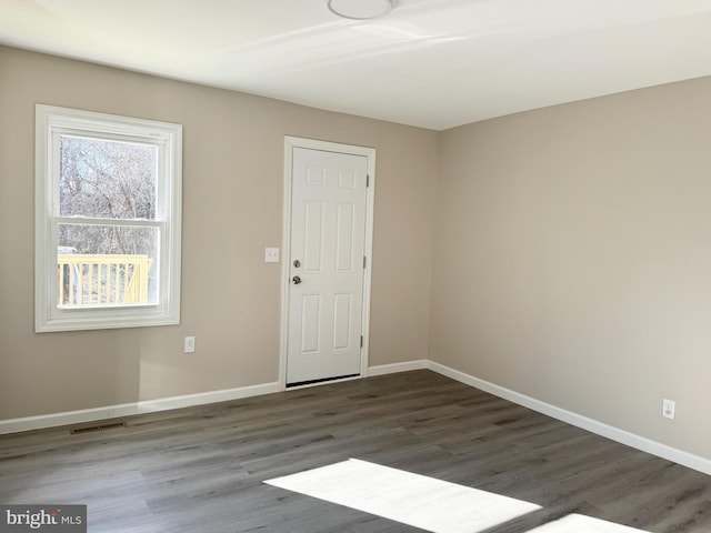 unfurnished room featuring dark hardwood / wood-style flooring