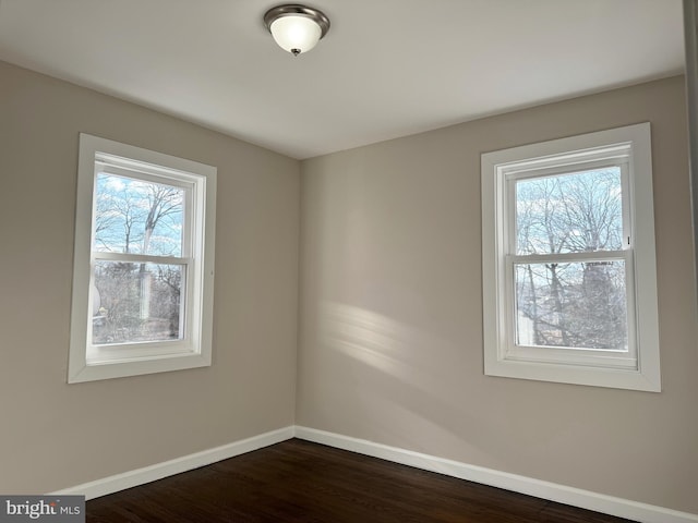 spare room with dark wood-type flooring