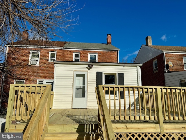 back of property featuring a wooden deck