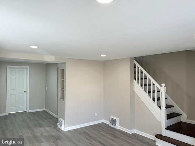 stairs with hardwood / wood-style floors