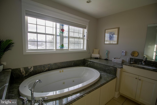 bathroom featuring tiled bath, tile patterned flooring, and vanity