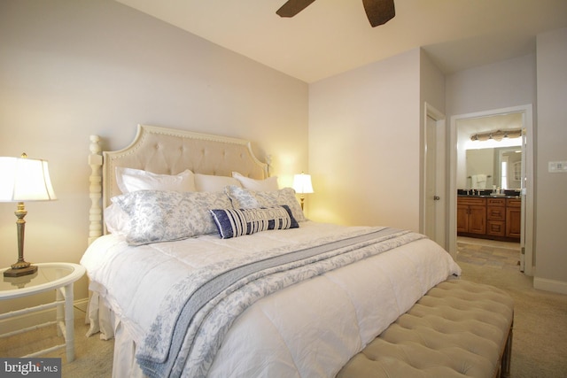 bedroom featuring ensuite bathroom, ceiling fan, and light colored carpet