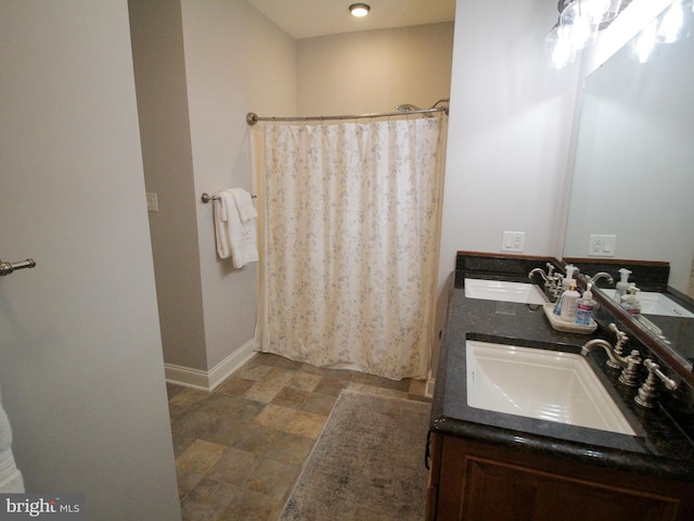 bathroom featuring vanity and curtained shower