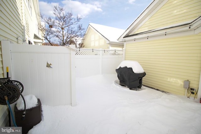 snow covered patio featuring grilling area