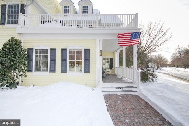 view of snow covered property entrance