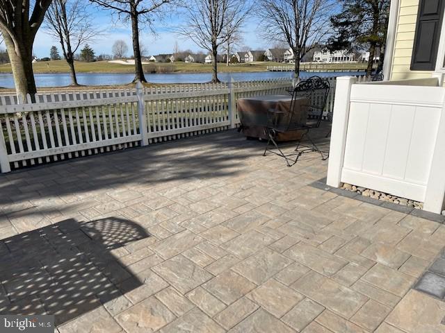 view of patio with a water view