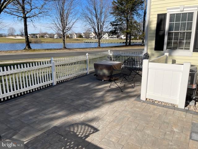 deck featuring a water view and a patio area