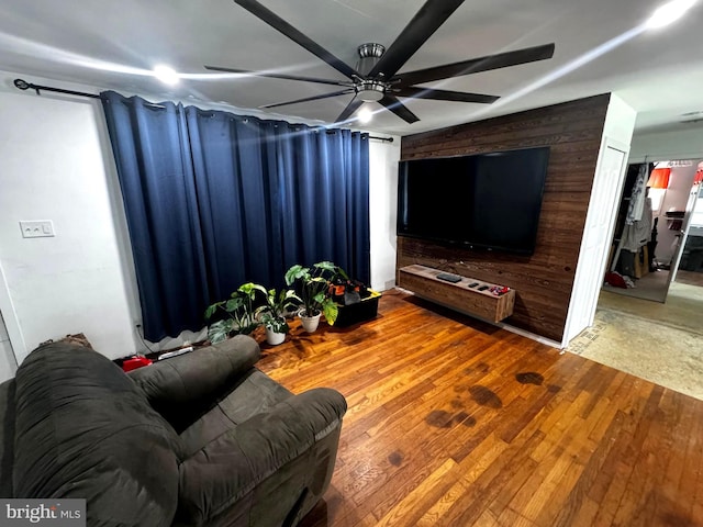 living room with ceiling fan and hardwood / wood-style floors